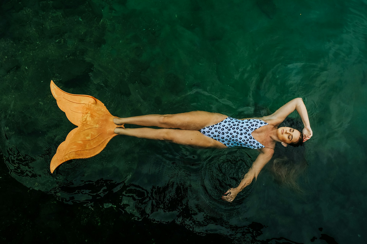 a female model posing in a swimsuit in a pool