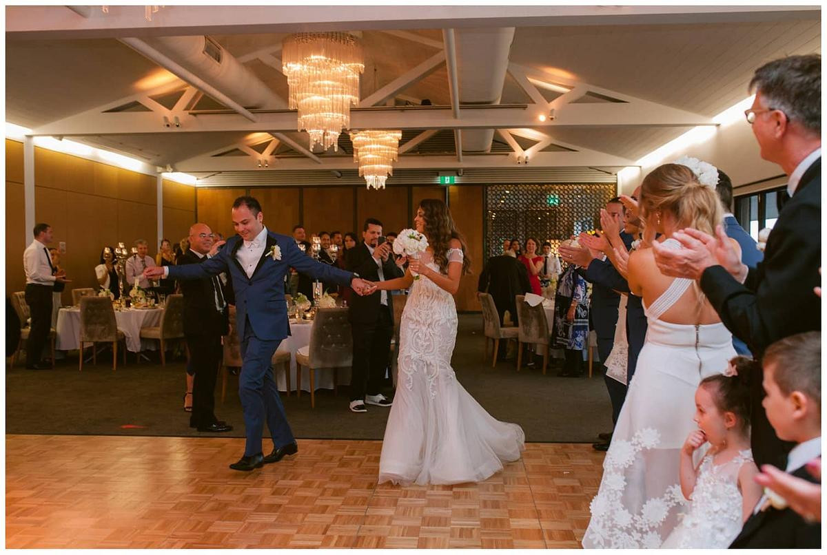 Joyful wedding photo of the newlyweds during the bridal entrance at Sergeants Mess Mosman.